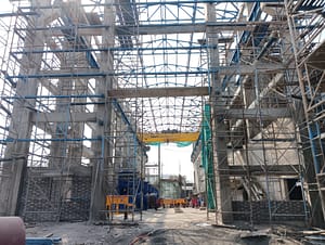 Interior of the pump house under assembly with large structural steel members.